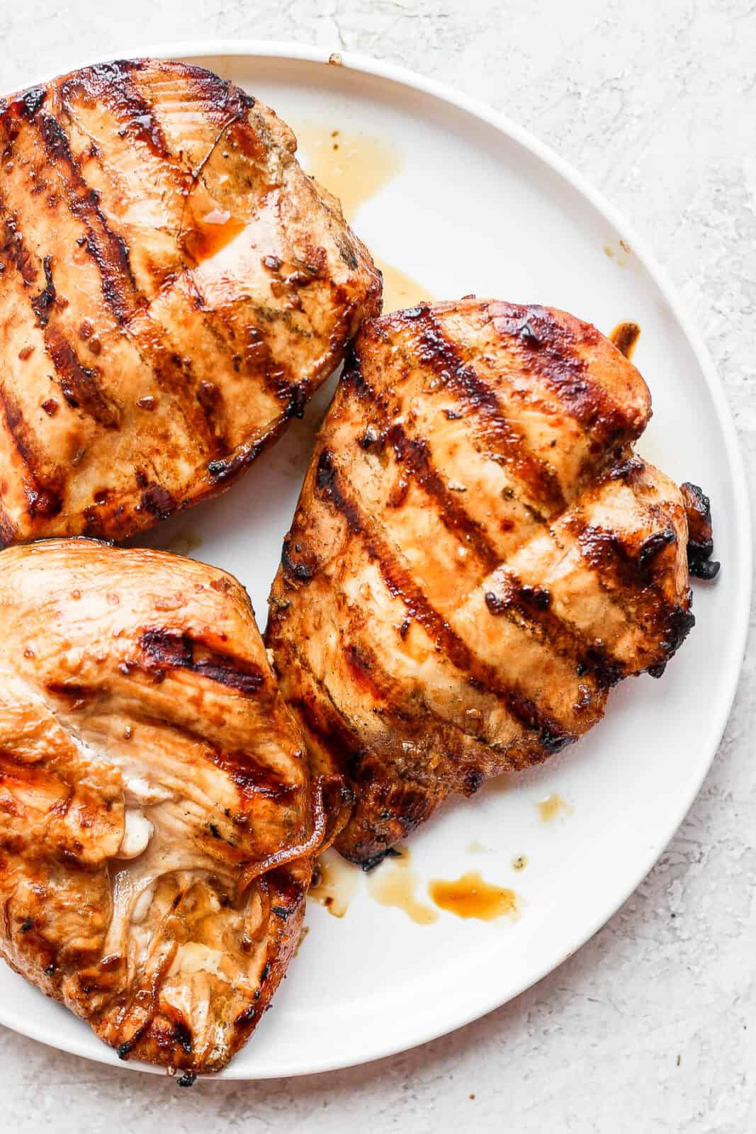 Grilled chicken breasts on a plate.