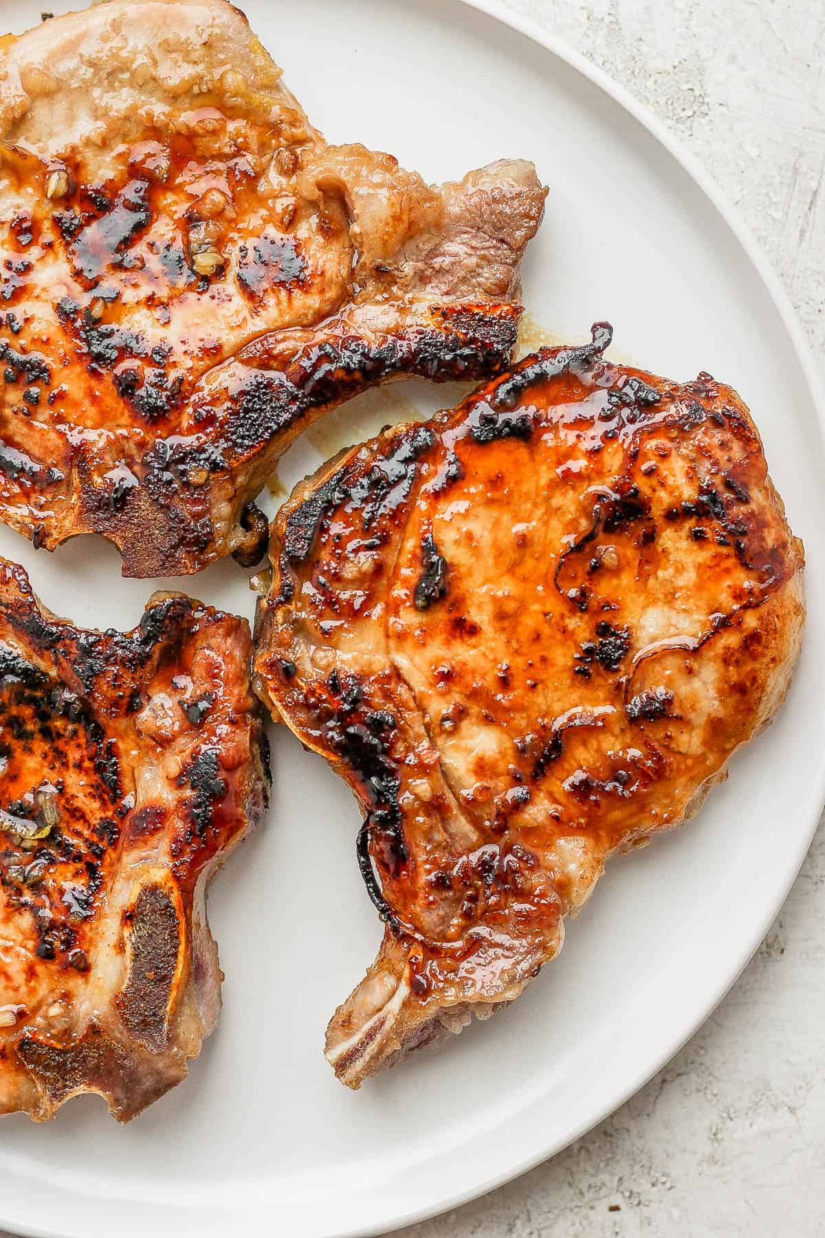 Cast iron pork chops on a plate.