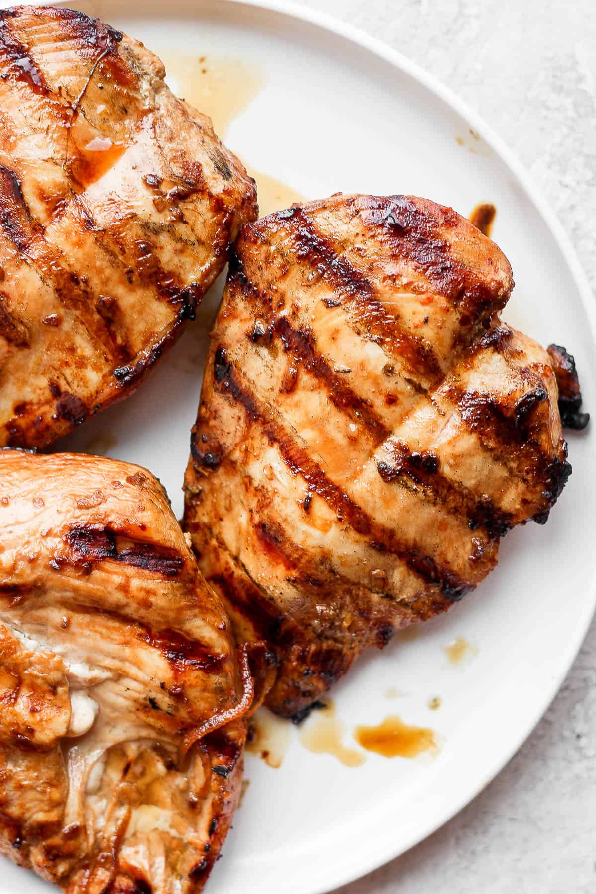 Grilled chicken breasts on a plate.