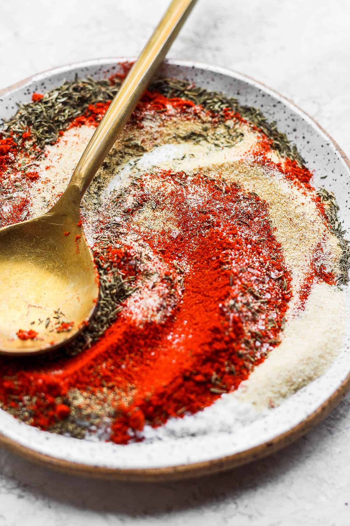 Chicken seasoning ingredients mixed on a plate.