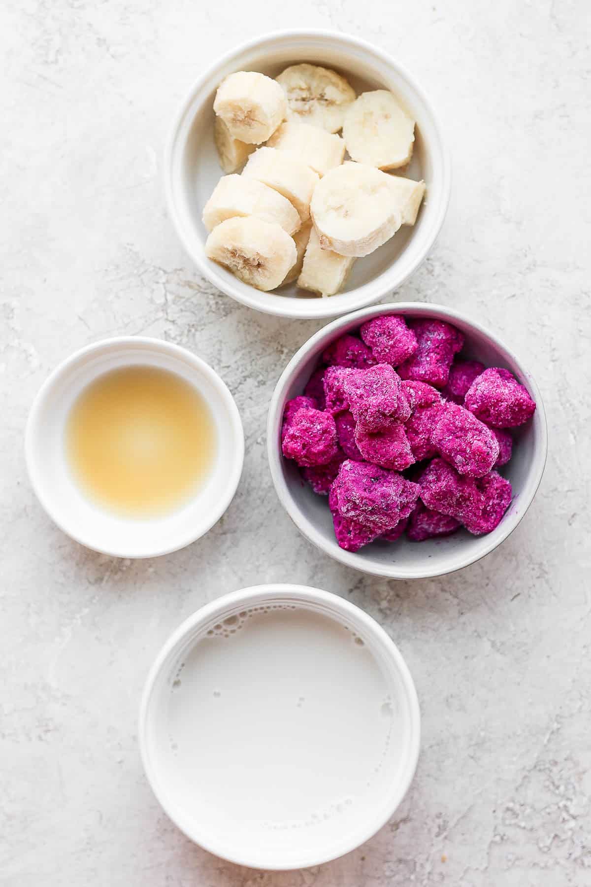 Dragonfruit smoothie ingredients in bowls.