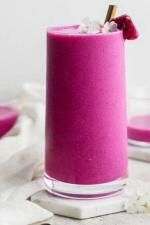 A tall glass filled with a dragonfruit smoothie.