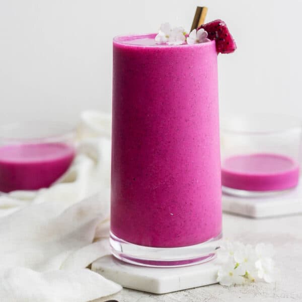 A tall glass filled with a dragonfruit smoothie.