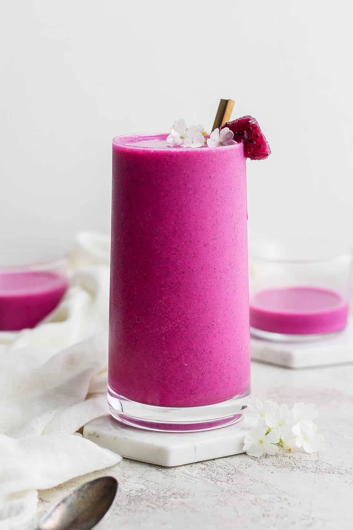 A dragonfruit smoothie in a glass.