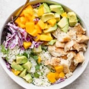 A fully assembled fish taco bowl in a white bowl.