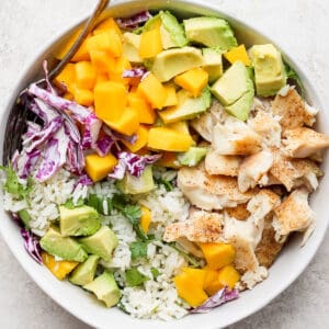 A fully assembled fish taco bowl in a white bowl.
