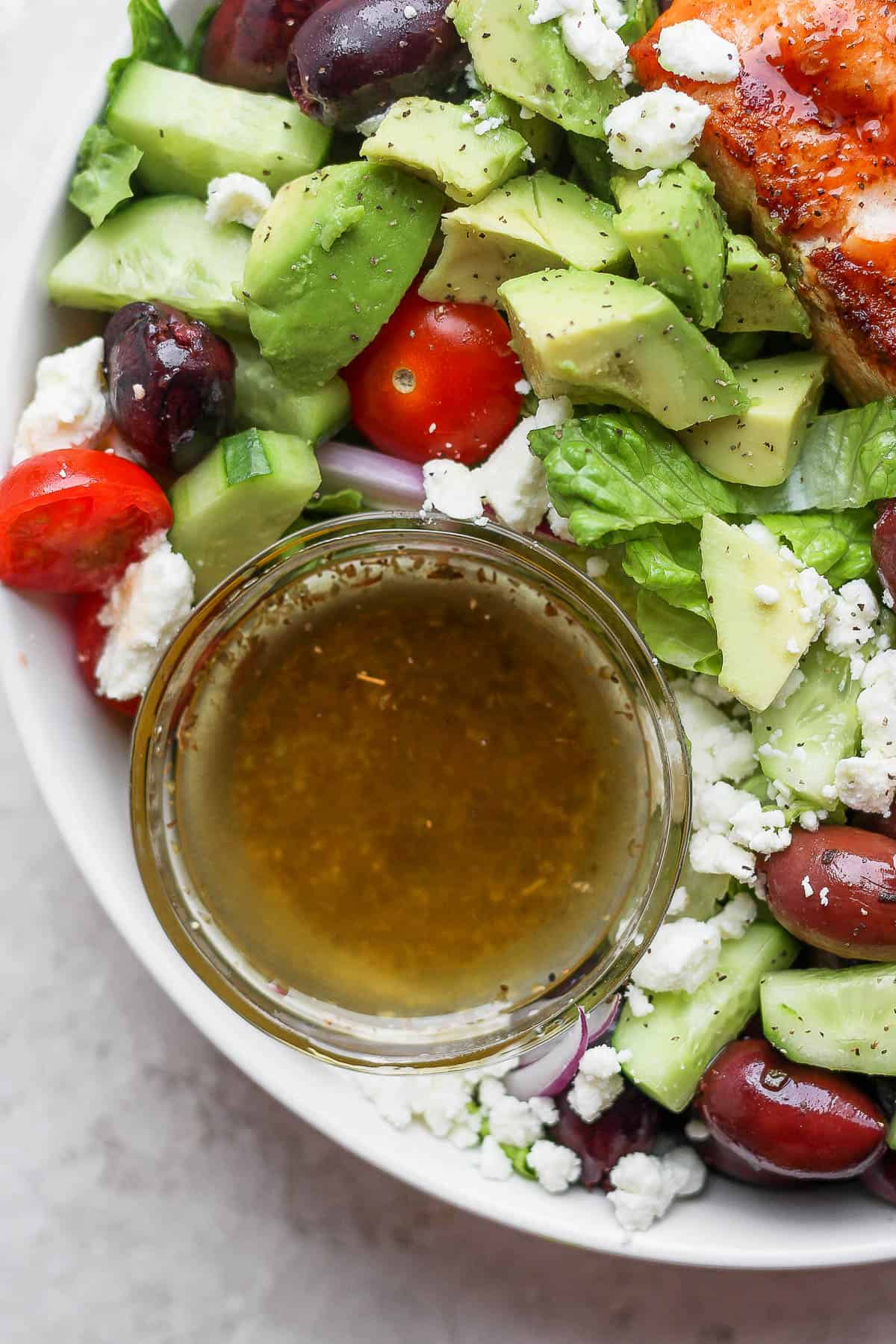 A small dish of greek vinaigrette in a salad.