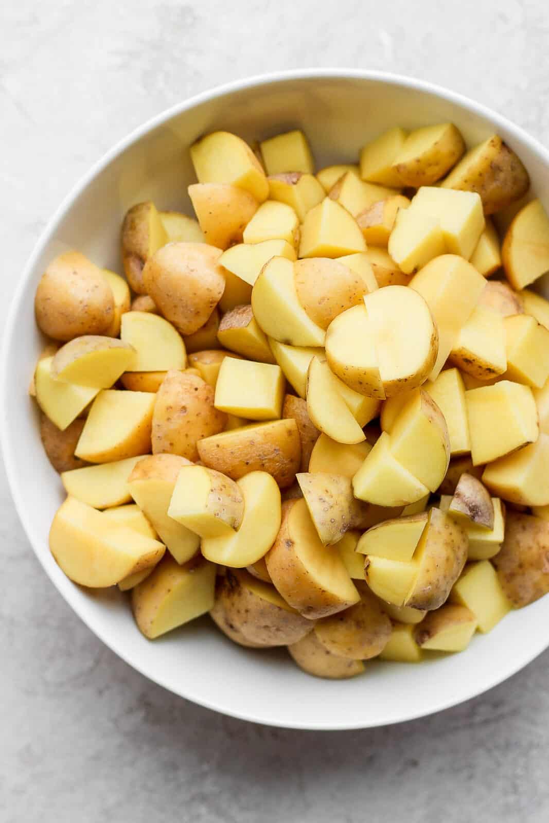 Cut up potatoes in a bowl.