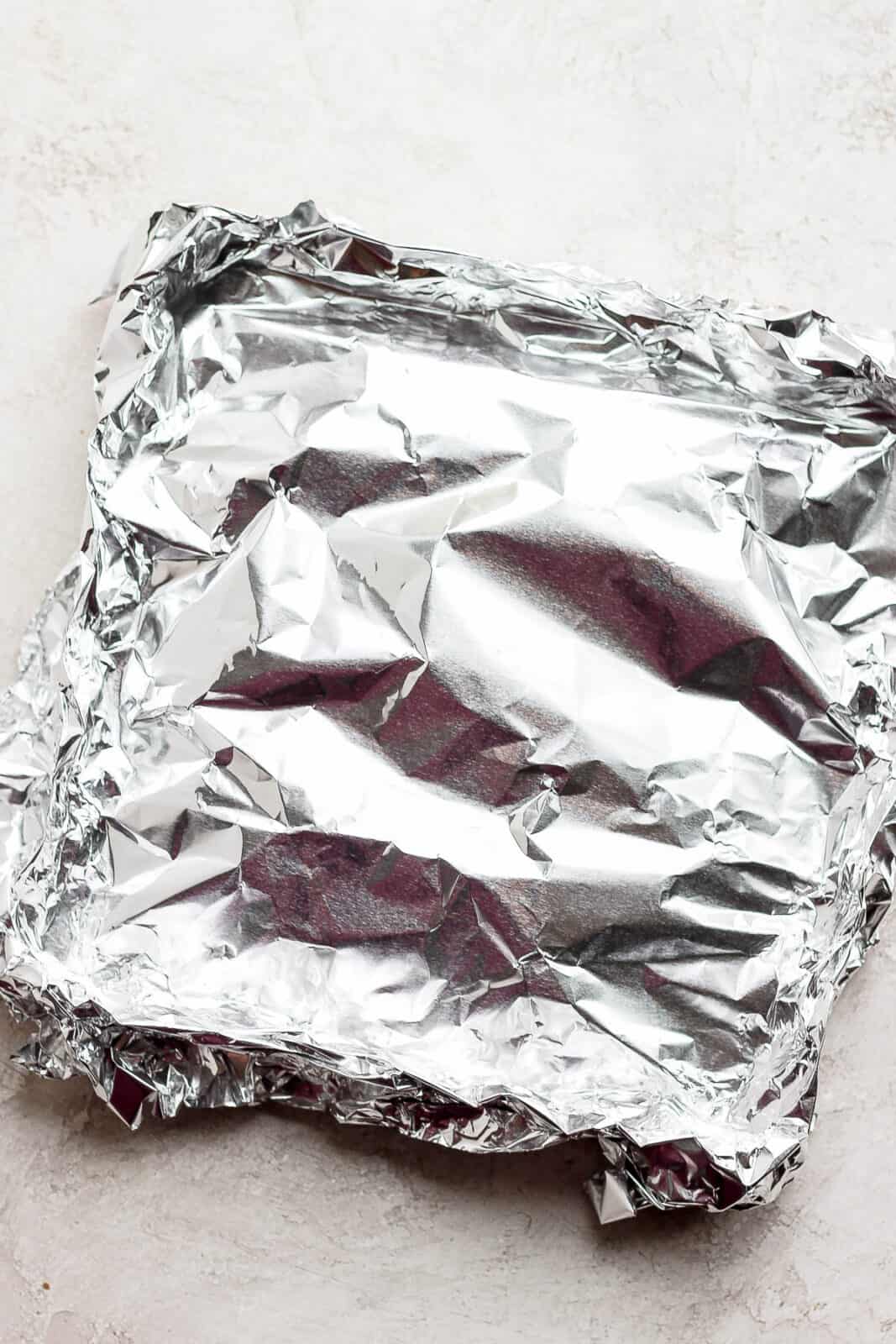 Cut up potatoes all wrapped up in foil.