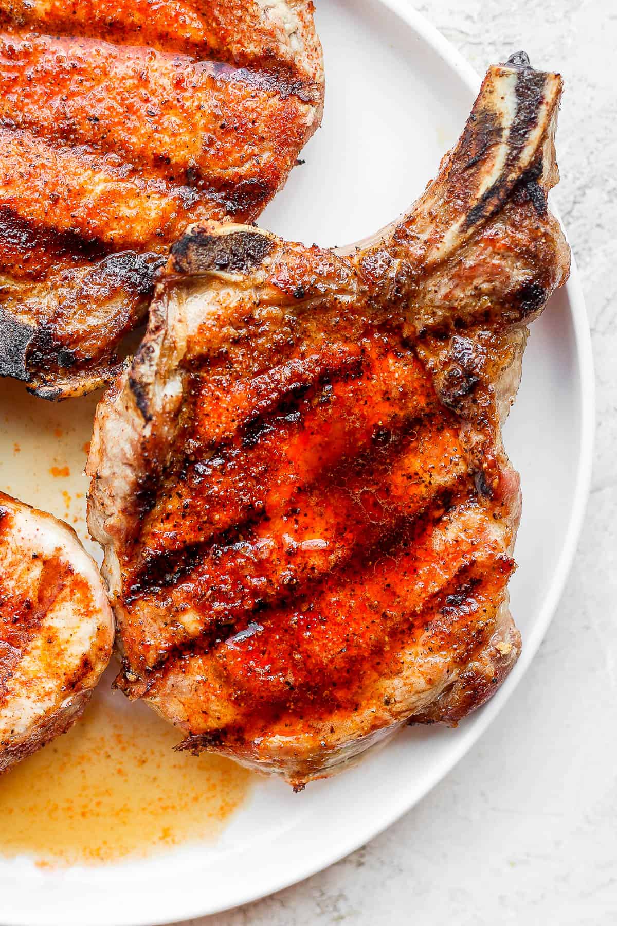 A plate of 3 grilled pork chops. 
