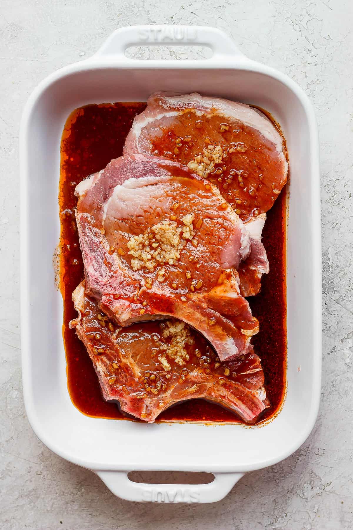 All-purpose marinade and pork chops in a shallow pan.