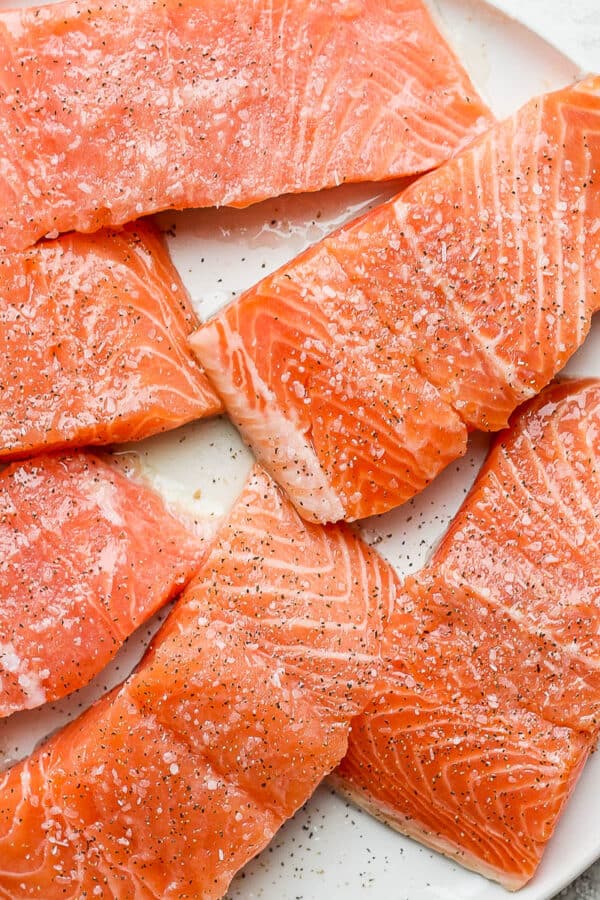 Salmon on a plate with salmon seasoning on top.