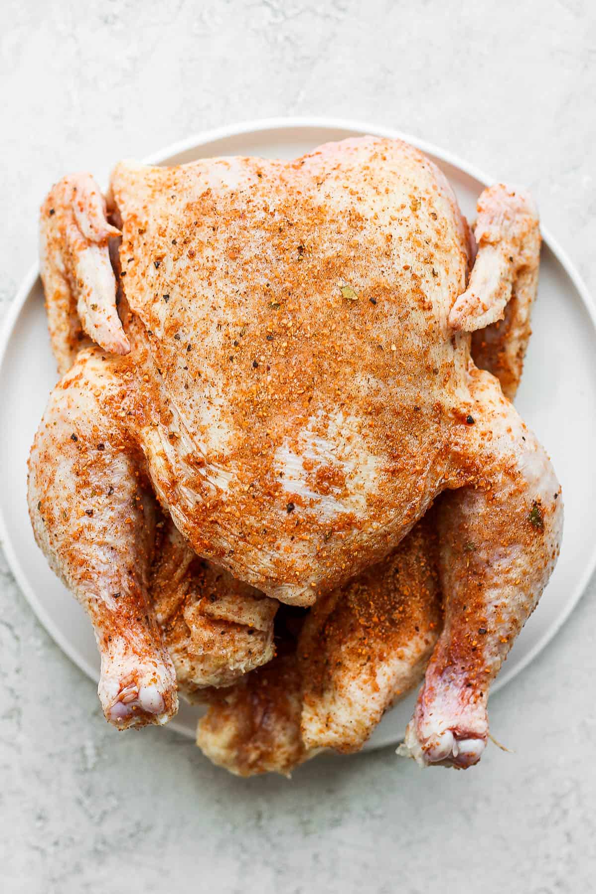 A whole chicken covered in smoked chicken dry rub. 