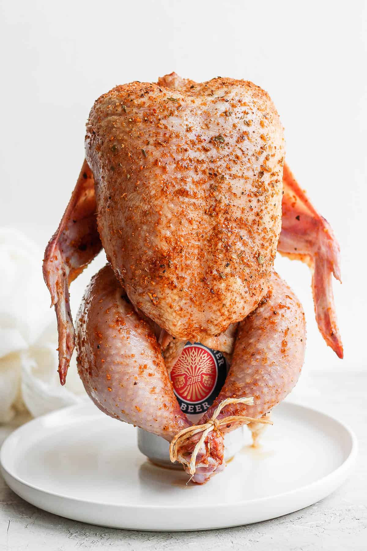 A beer can chicken prepped and ready to go on the grill. 