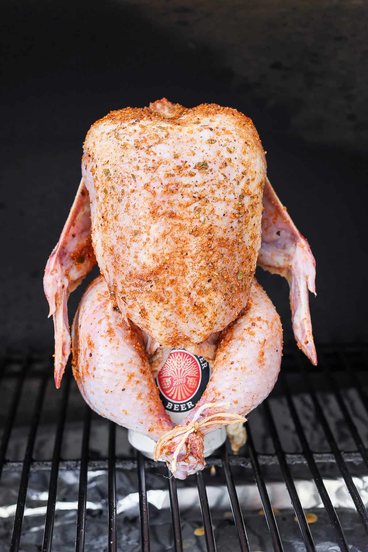 A beer can chicken on the smoker. 