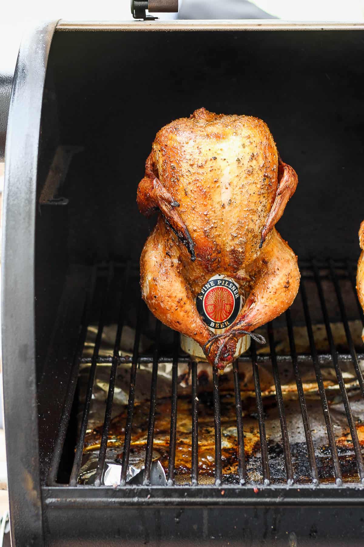 Smoked beer can chicken on the smoker. 