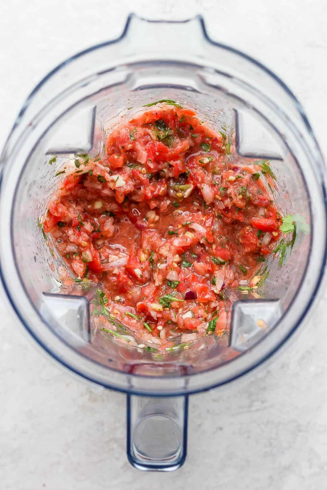 Top view of blender with salsa inside. 