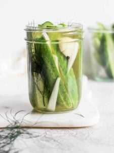 Easy refrigerator dill pickles in a jar on a countertop.