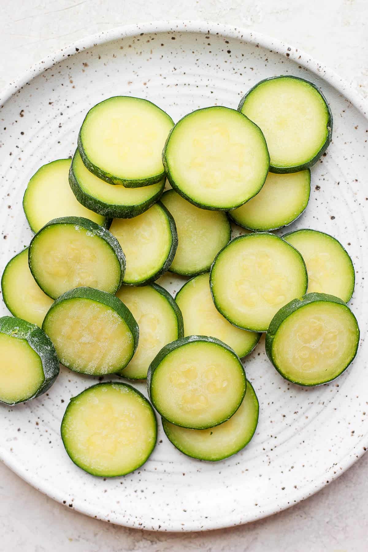 Frozen zucchini slices on a plate.