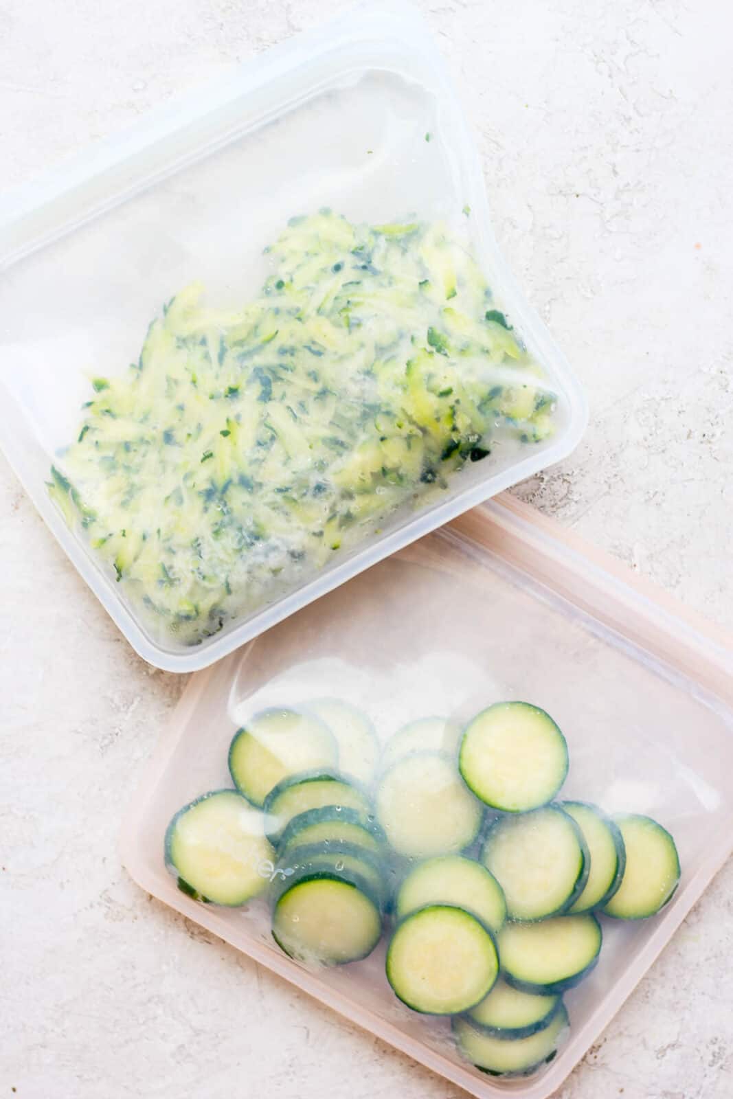 One bag of frozen shredded zucchini and a bag of frozen zucchini slices. 