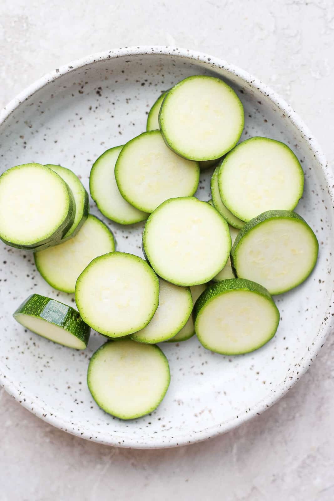 Slices of zucchini in a bowl.