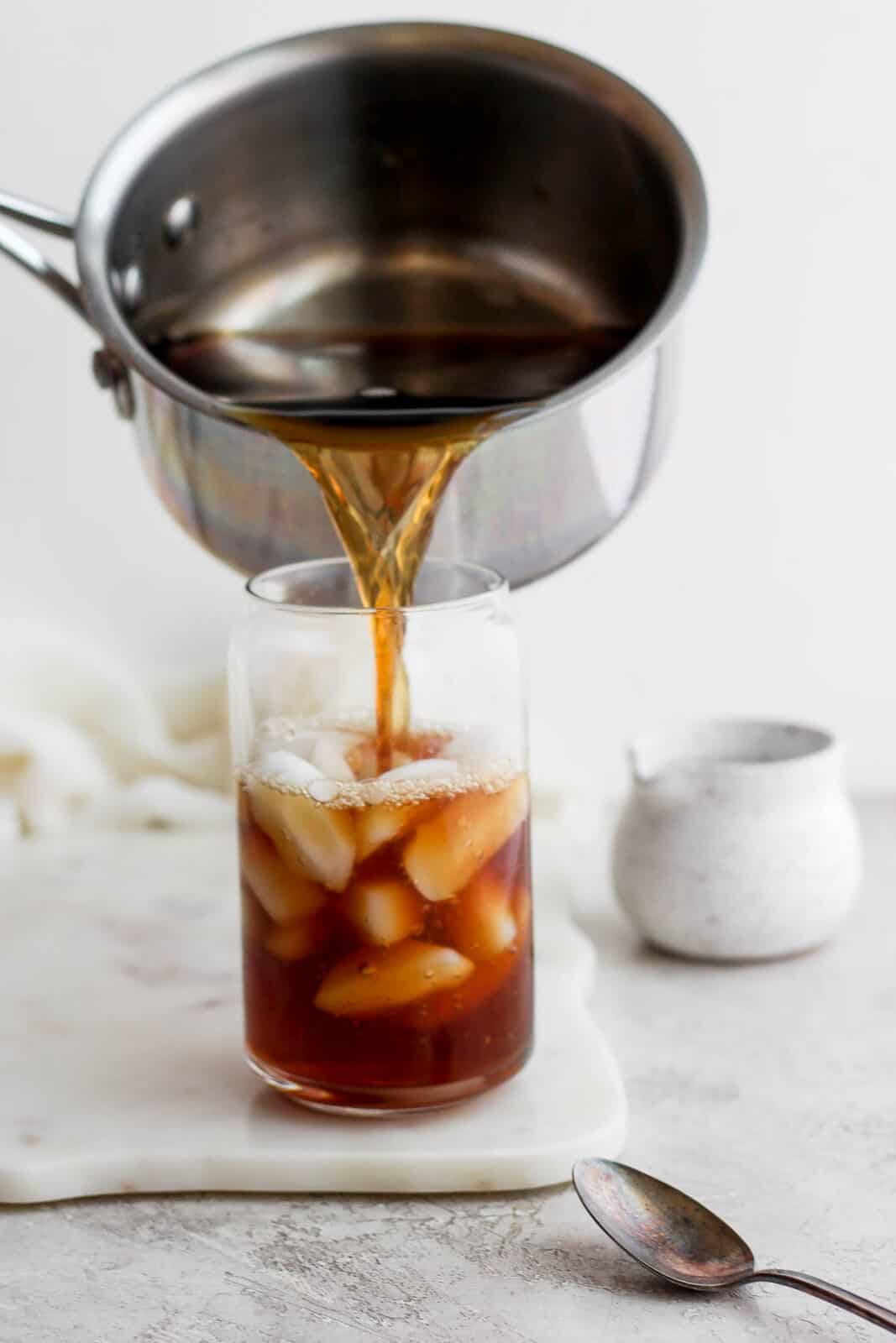 Pouring early grey tea over ice.