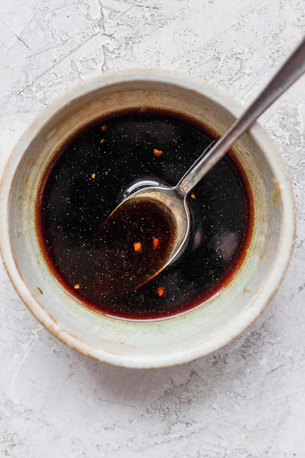 Poke sauce in a bowl with a spoon.