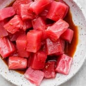 Pieces of raw tuna marinating in poke sauce.