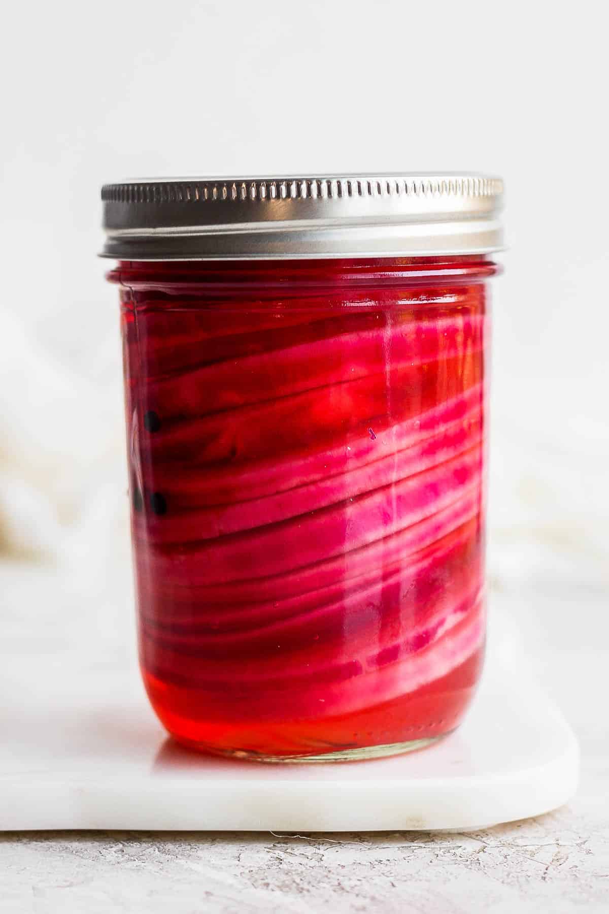 Mason jar with quick pickled onions.