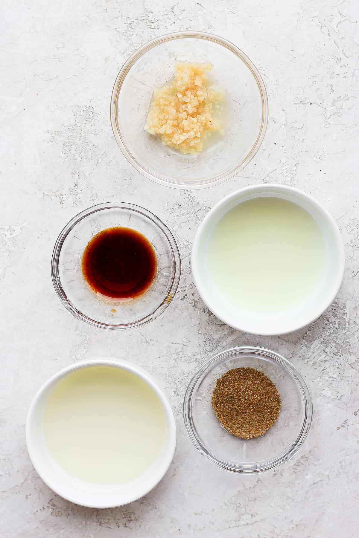 Shrimp marinade ingredients in separate bowls.