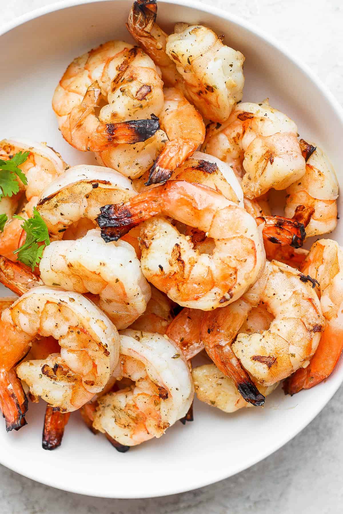 Marinated shrimp that have been grilled in a bowl.