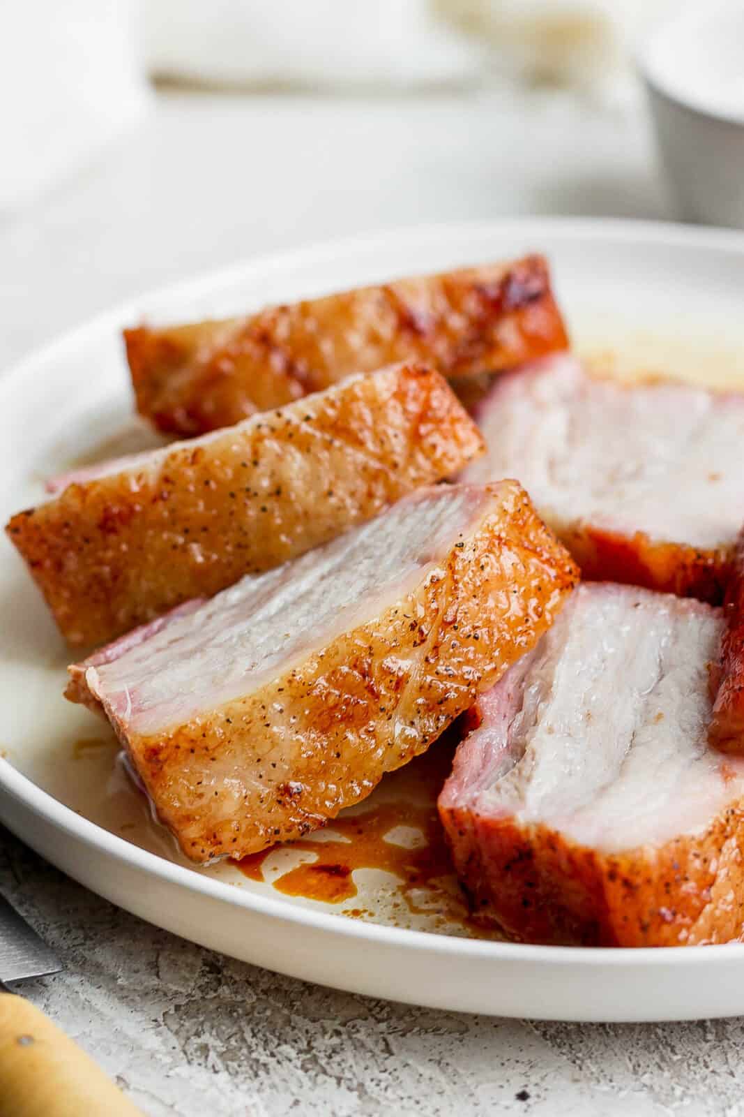 A plate of pork belly slices.