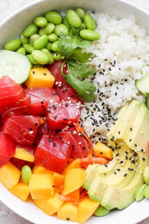 A tuna poke bowl with sushi rice, tuna, mango and avocado.