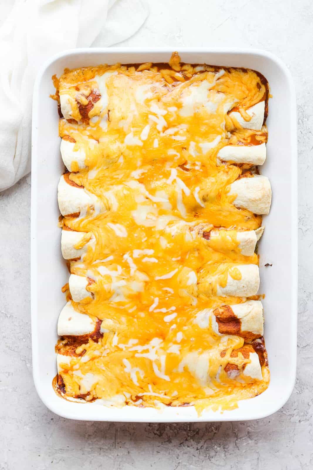 A pan of chicken enchiladas just out of the oven. 