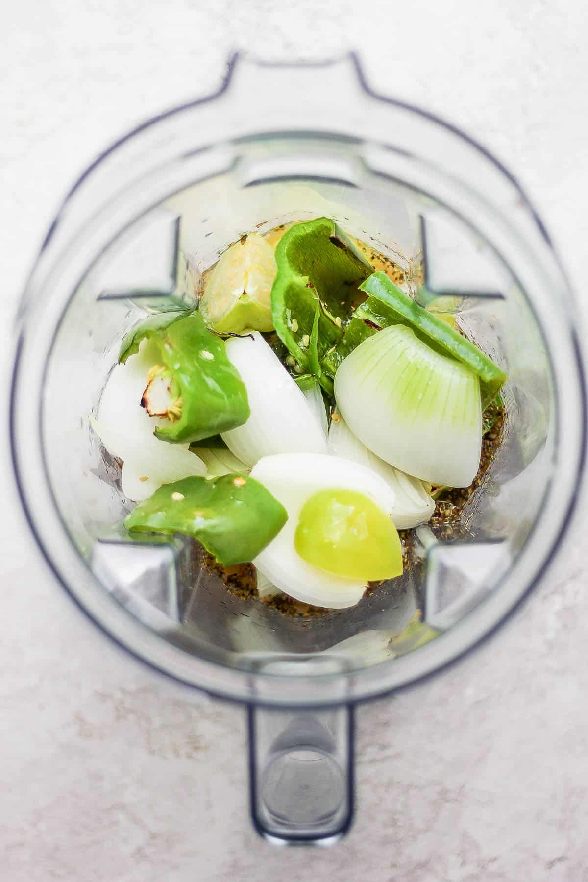 All green enchilada sauce ingredients in a blender before blending.