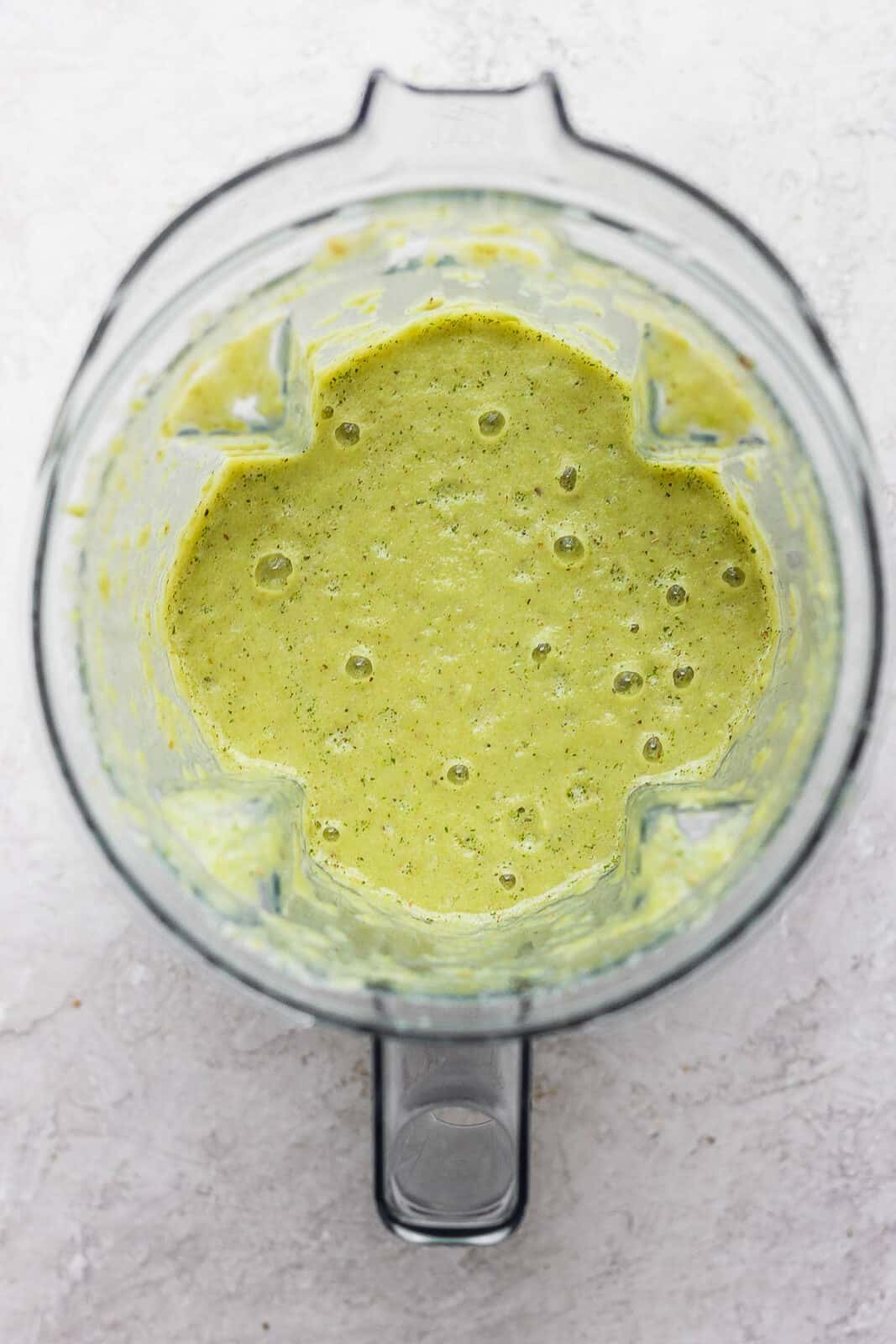Blended green enchilada sauce in a blender.