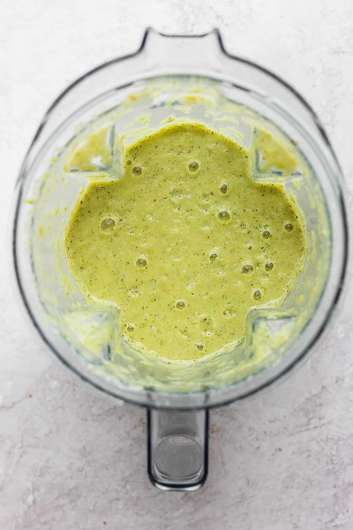 Blended green enchilada sauce in a blender.