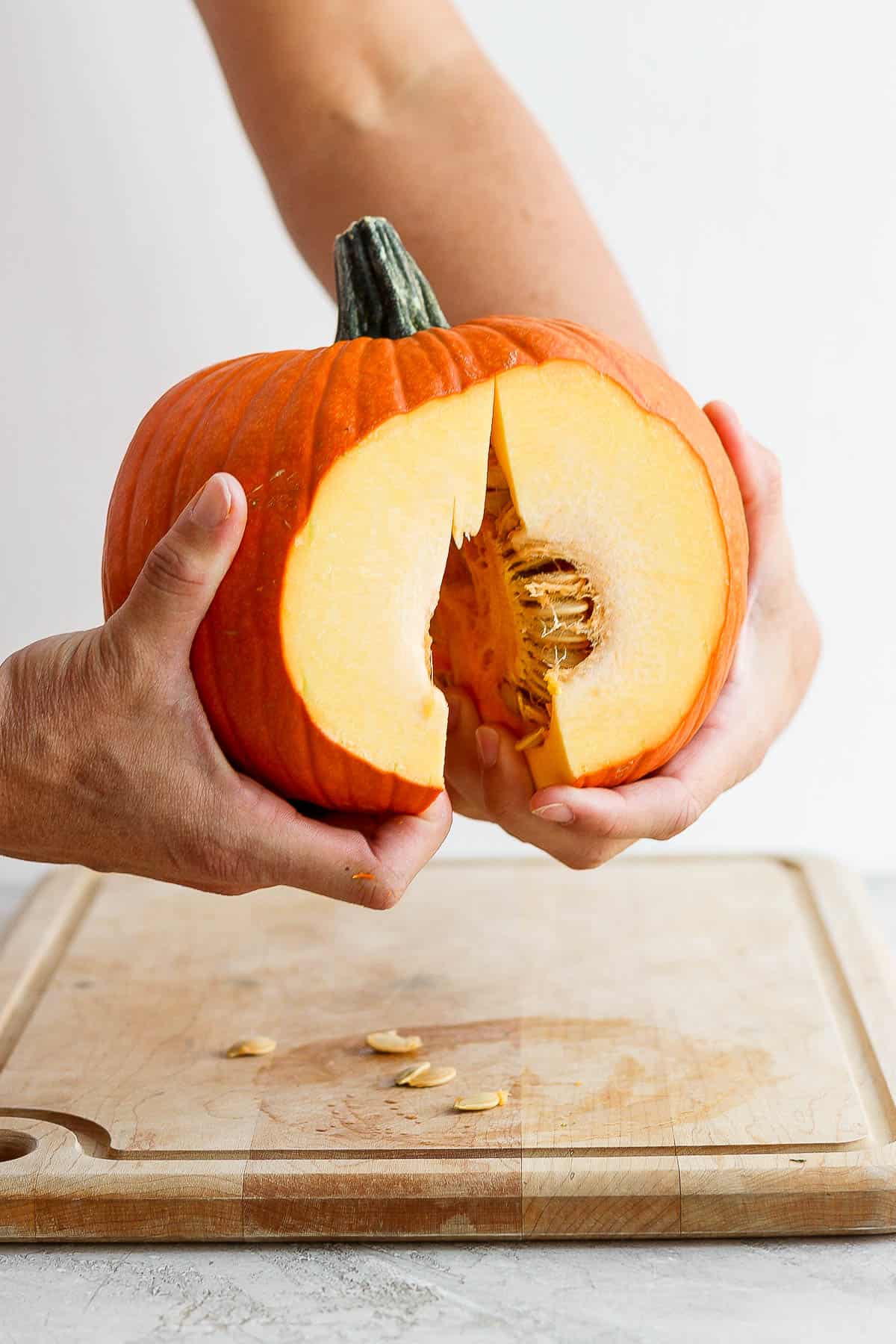 A pumpkin being pulled in half. 