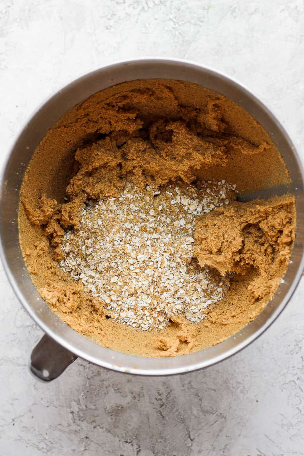 Monster cookie dough in a bowl with quick-cooking oats.