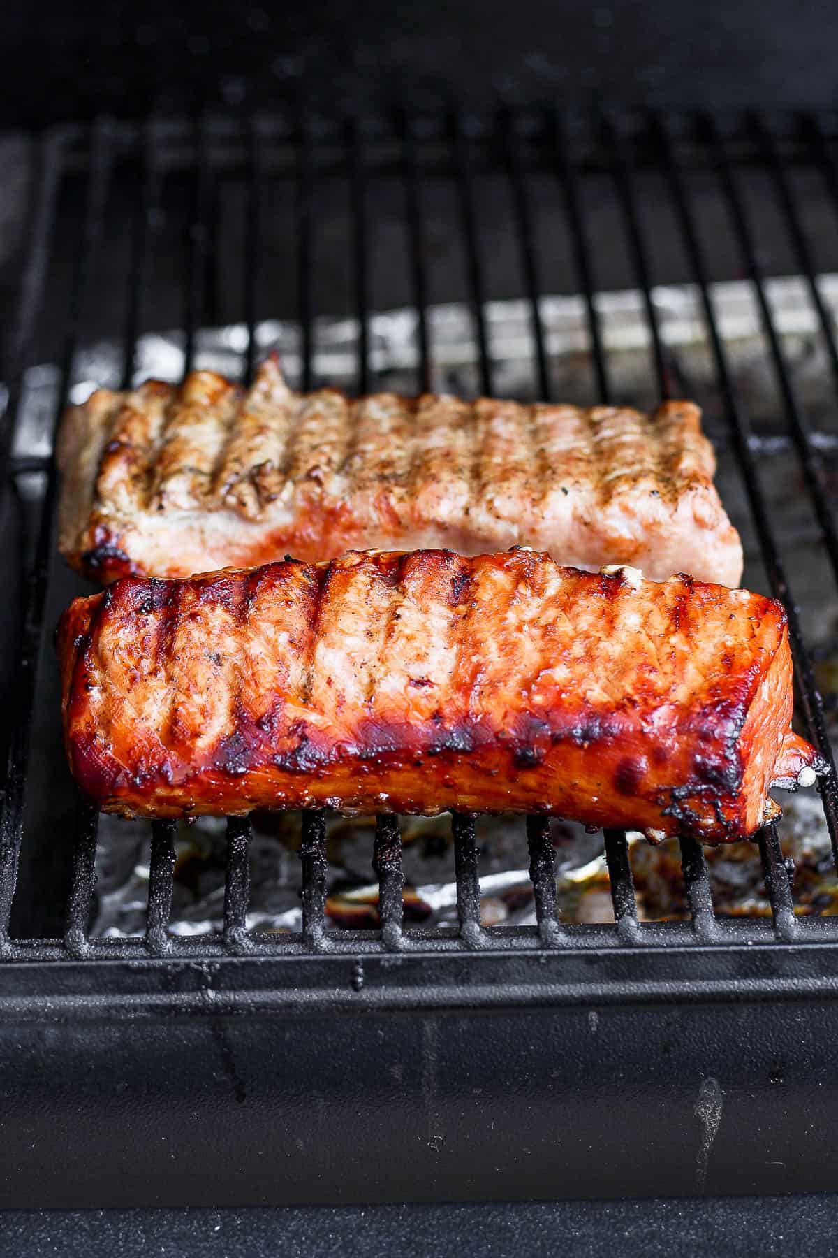 A marinated pork loin on a smoker.