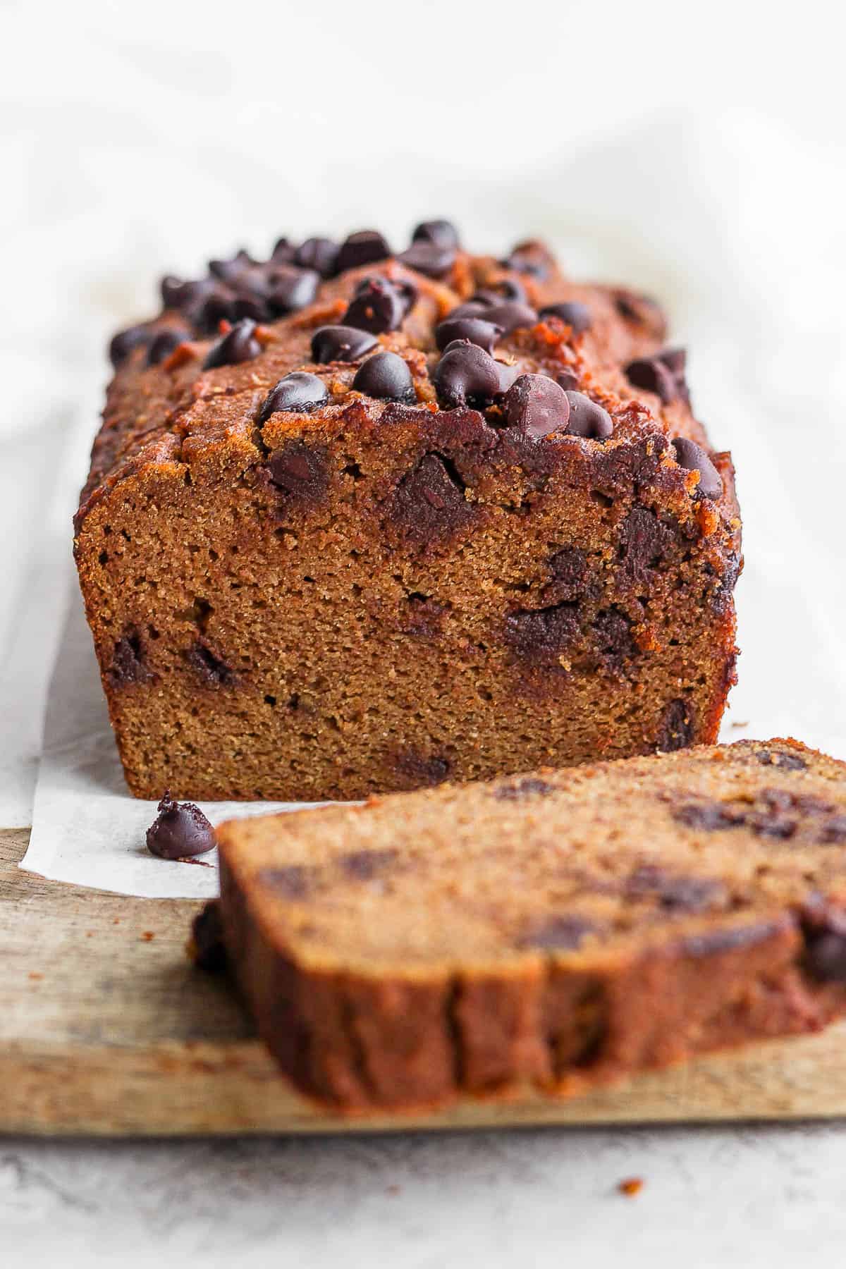 Pumpkin bread with a slice cut off.