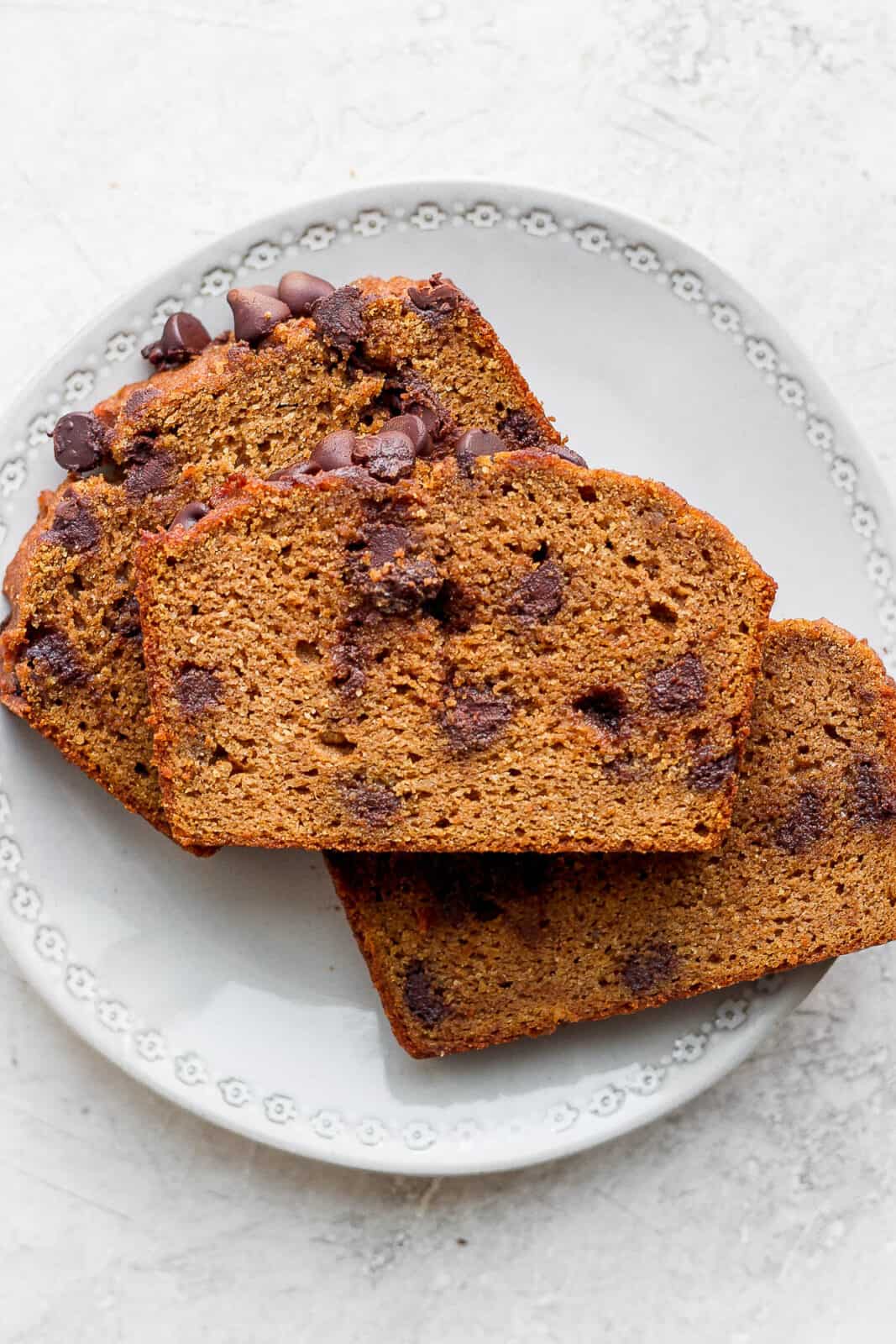 Three slices of pumpkin bread on a plate.