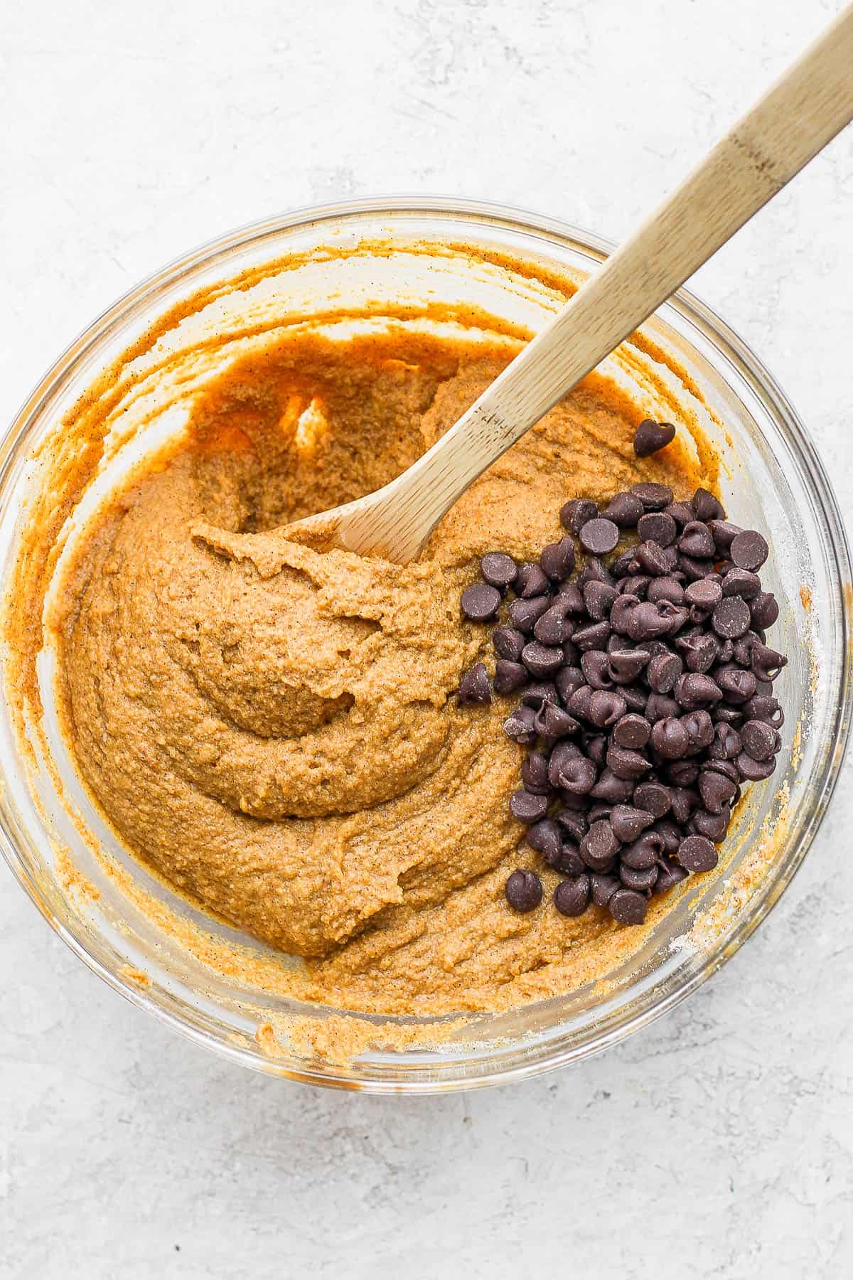 Pumpkin batter in a bowl with chocolate chips.