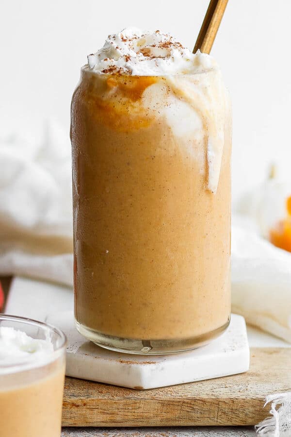 Glass full of pumpkin smoothie.