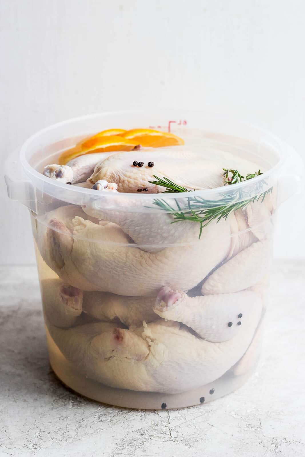 Two whole, raw chickens in a smoked chicken brine. 