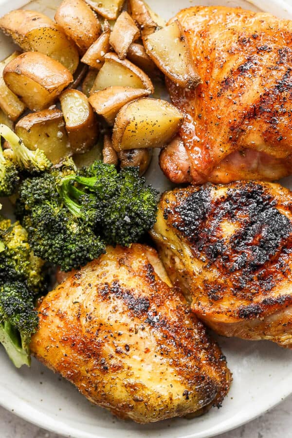 Plate of smoked chicken thighs, broccoli and potatoes.