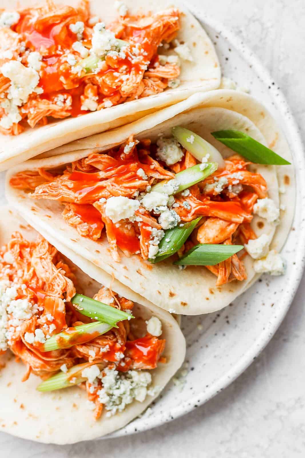 Buffalo chicken tacos on a plate.