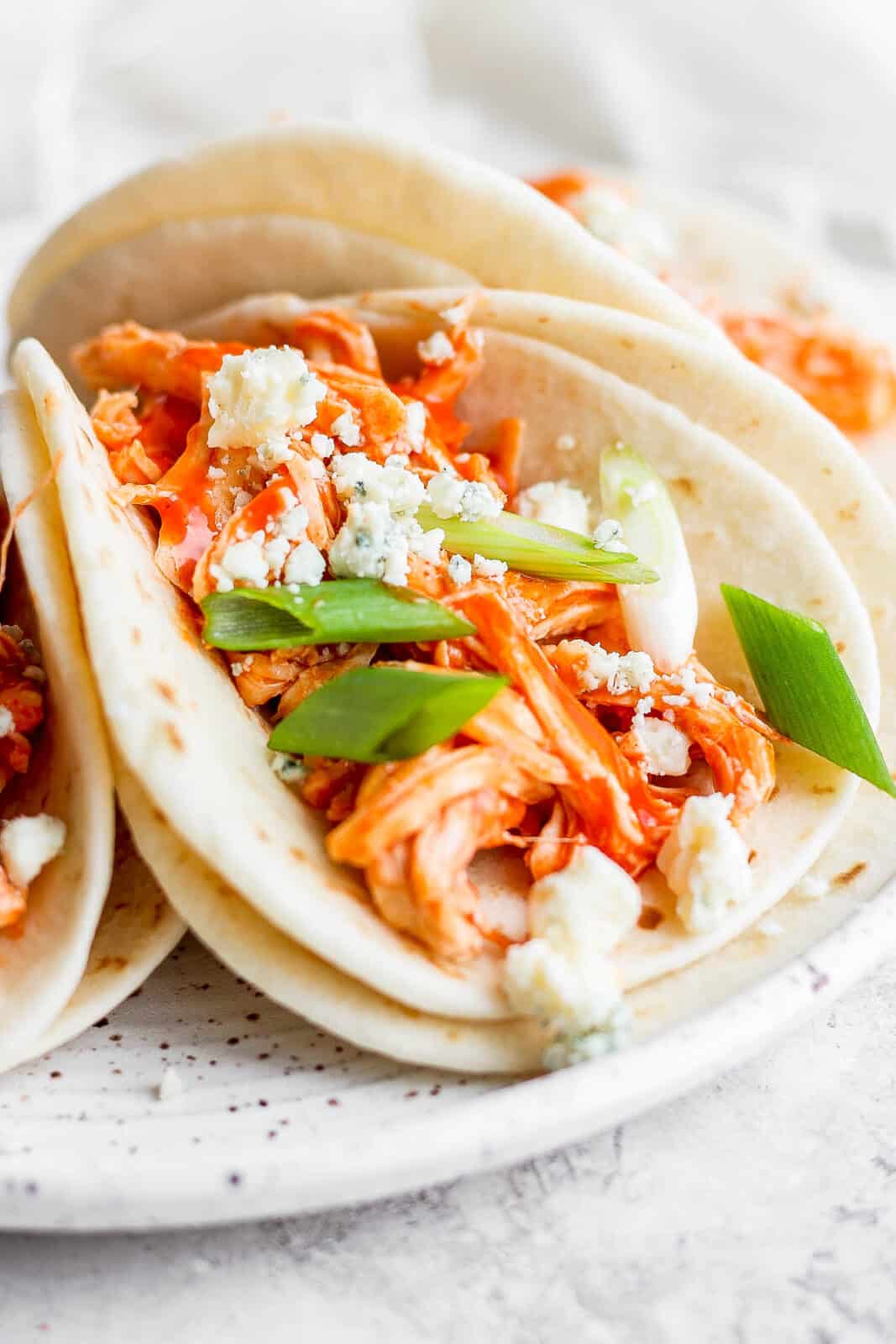 Buffalo chicken tacos on a plate.