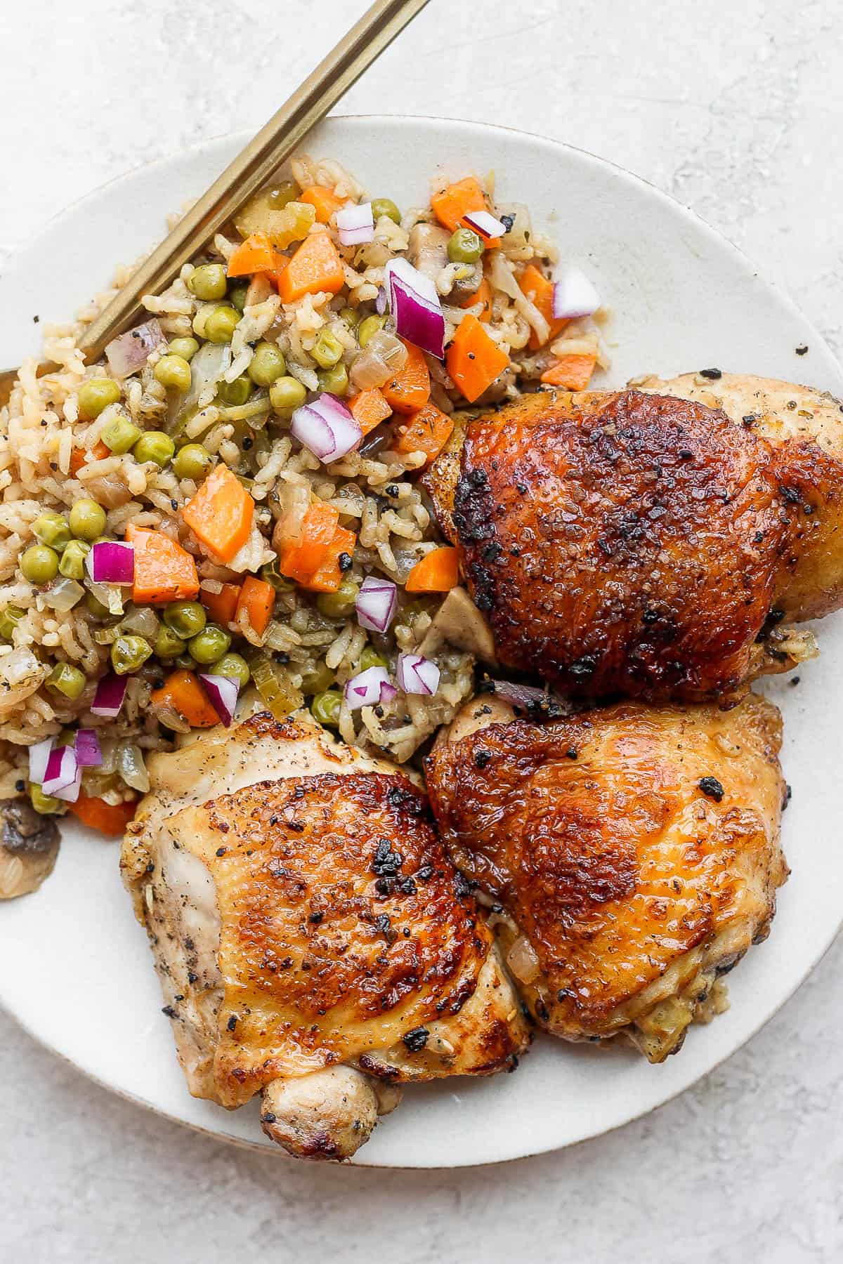 Baked chicken and rice on a plate.