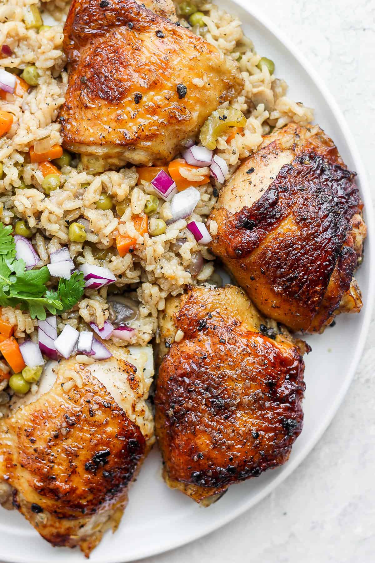 Baked chicken and rice on a plate.